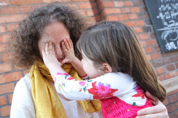 child playing with her mother 