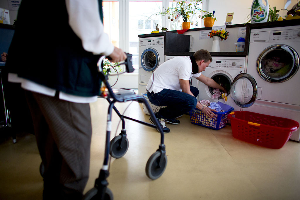 people standing by washing machine