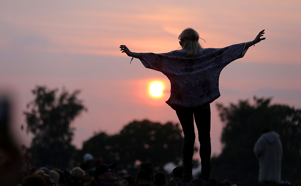 happy woman enjoying a sunset in england