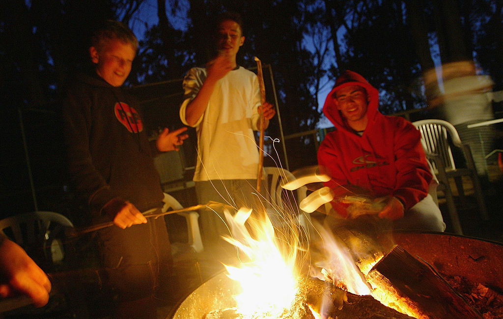 People standing around a campfire