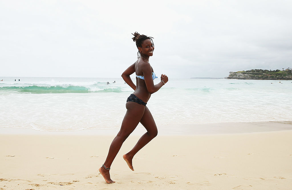 happy woman running on beach