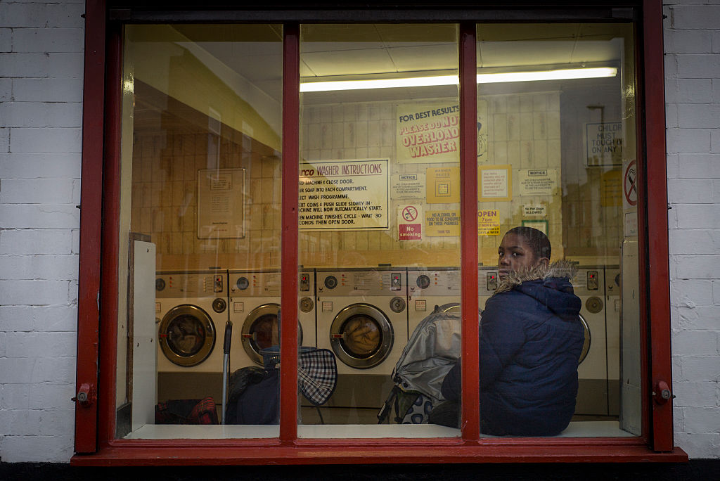 kid sitting in laundromat