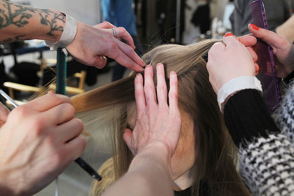 A model gets her hair done backstage