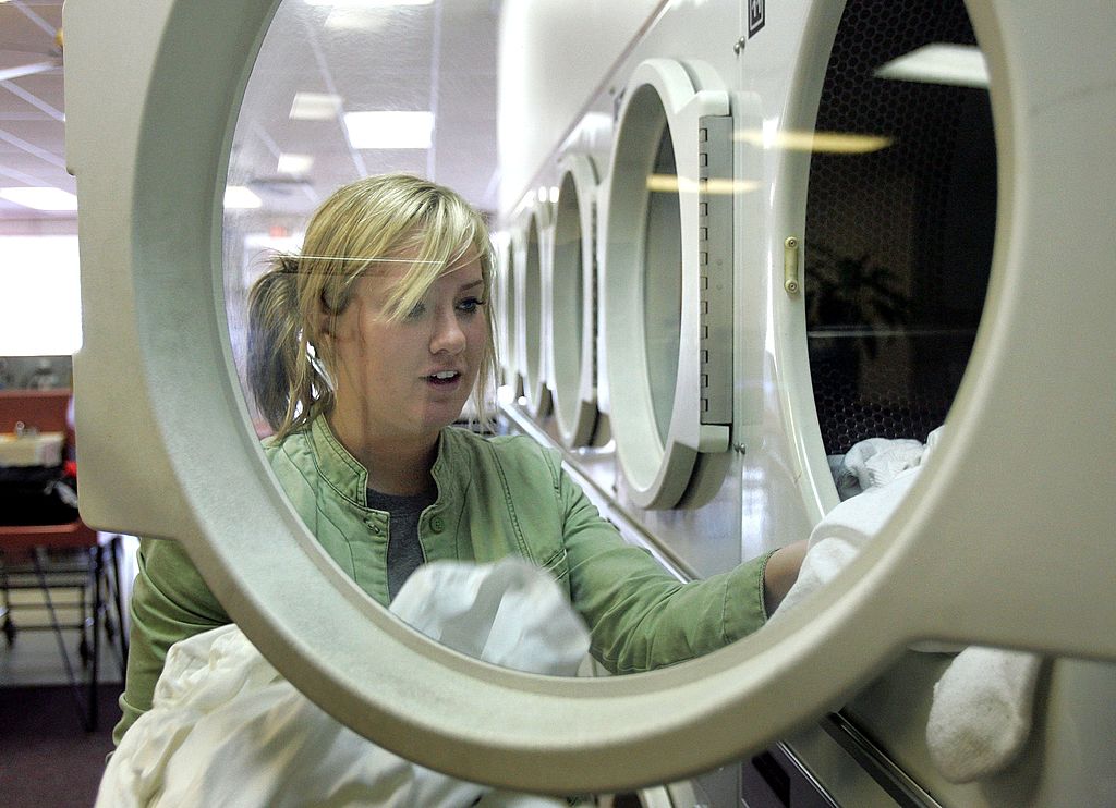 woman taking clothes out of washer