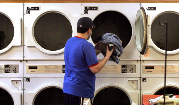 man taking clothes out of washer