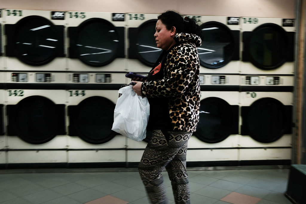 woman walking through laundromat