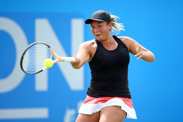 female tennis player hitting ball