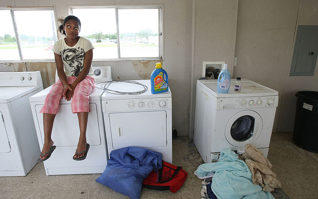 woman sitting on washing machine