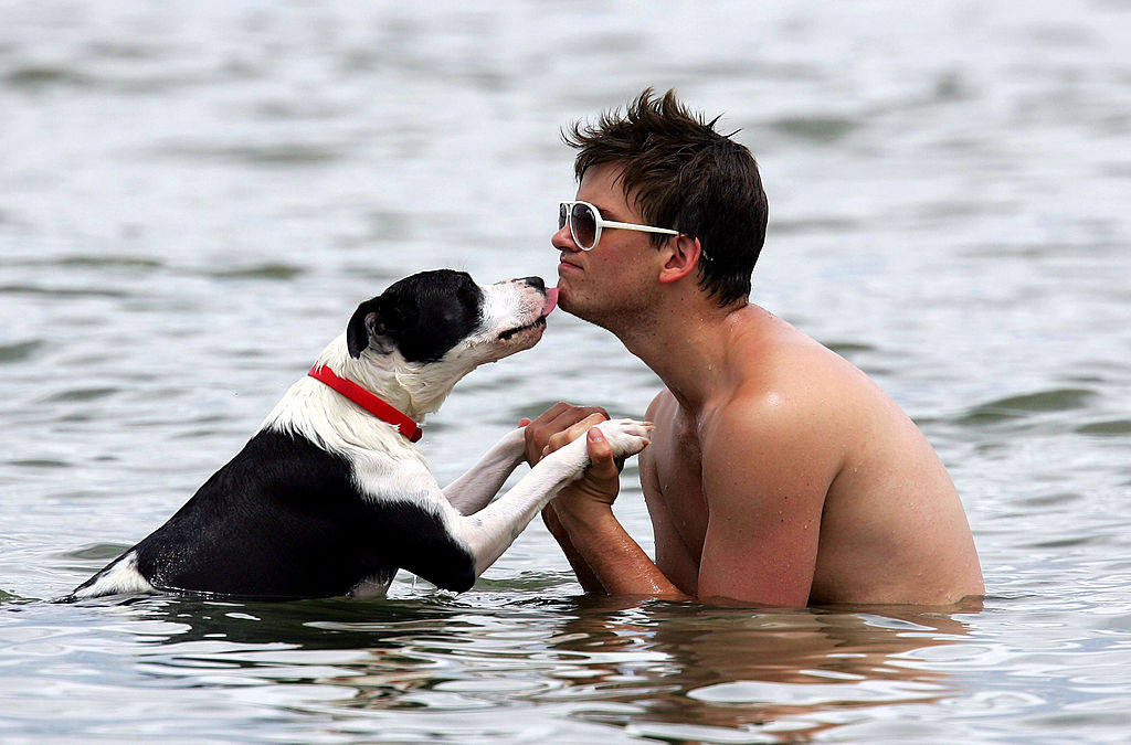 man swimming with his dog