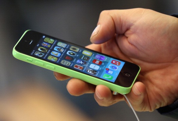 person holding iPhone 5c