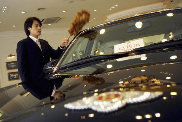 car salesman cleaning car