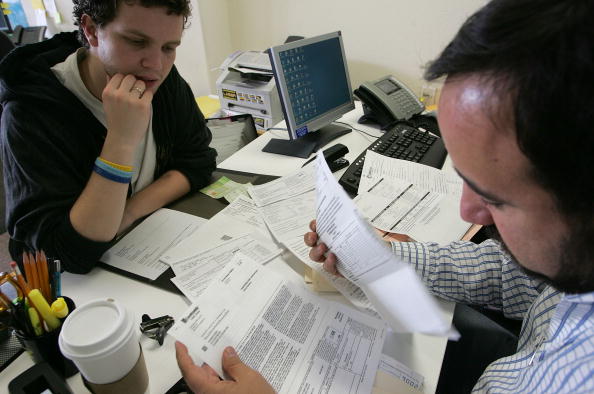 people doing paperwork in office