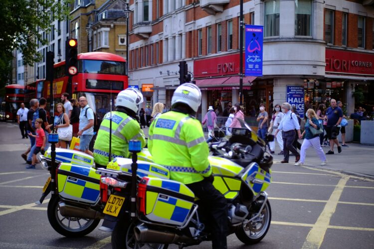 people in green and yellow jacket riding motorcycle during daytime