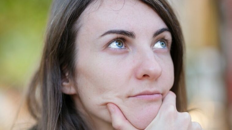 a woman with her chin resting on her hand
